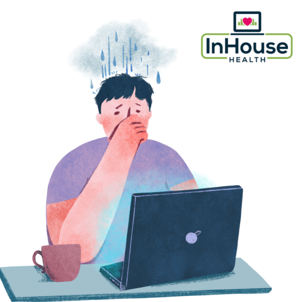 person at desk with rain cloud over his head