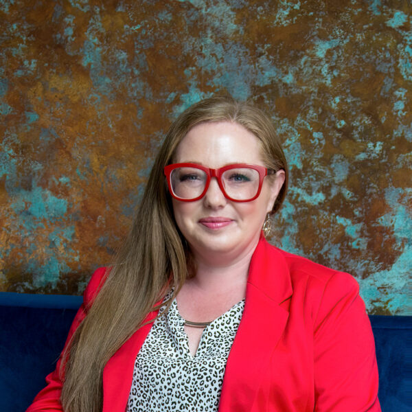 Emma Fusari smiling wearing read glasses